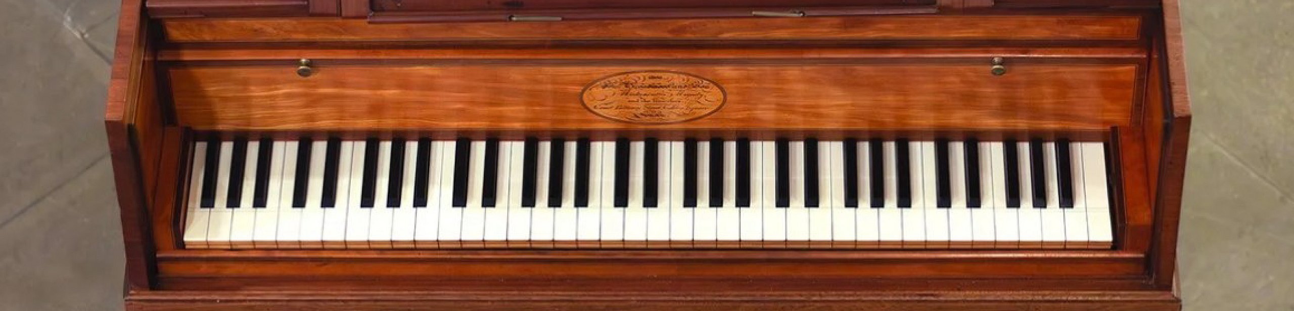  Exhibition poster for ‘The Pianoforte Age’, featuring an image of a historical pianoforte at the top centre, with the title and subtitle ‘Music and Modernity Before the Modern Piano’ below, and two boxes with a grey background containing event details and opening hours
