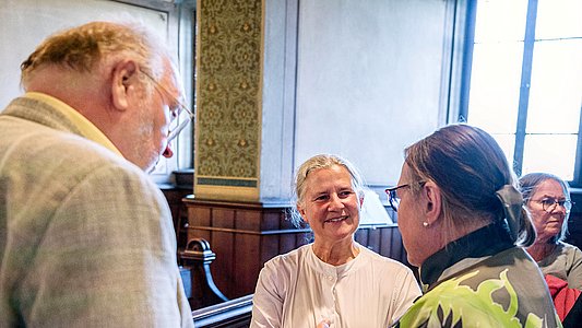 Rektorin Professorin Dr. Dr. hc. Karla Pollmann (Mitte) spricht mit Claudia Schöning-Kalender (rechts, Rückansicht) und ihrem Mann (links, Rückansicht)