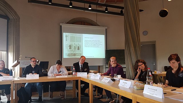 Photo: MUT Participants of the workshop discussing; screen with presentation in the background