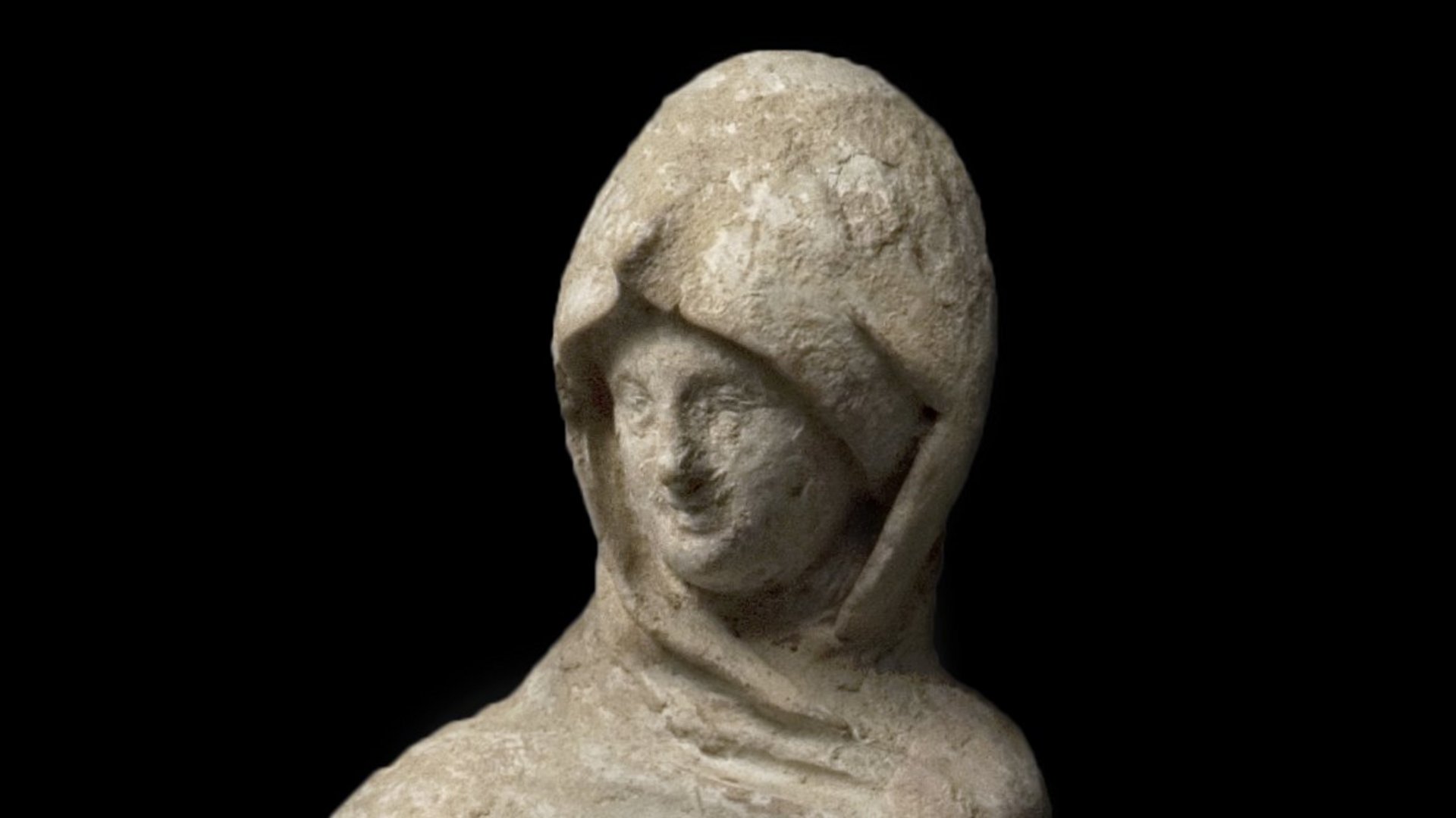 Female robed figure, the cloak pulled over her head and one hand put into the cloak; the other holds a fan or mirror