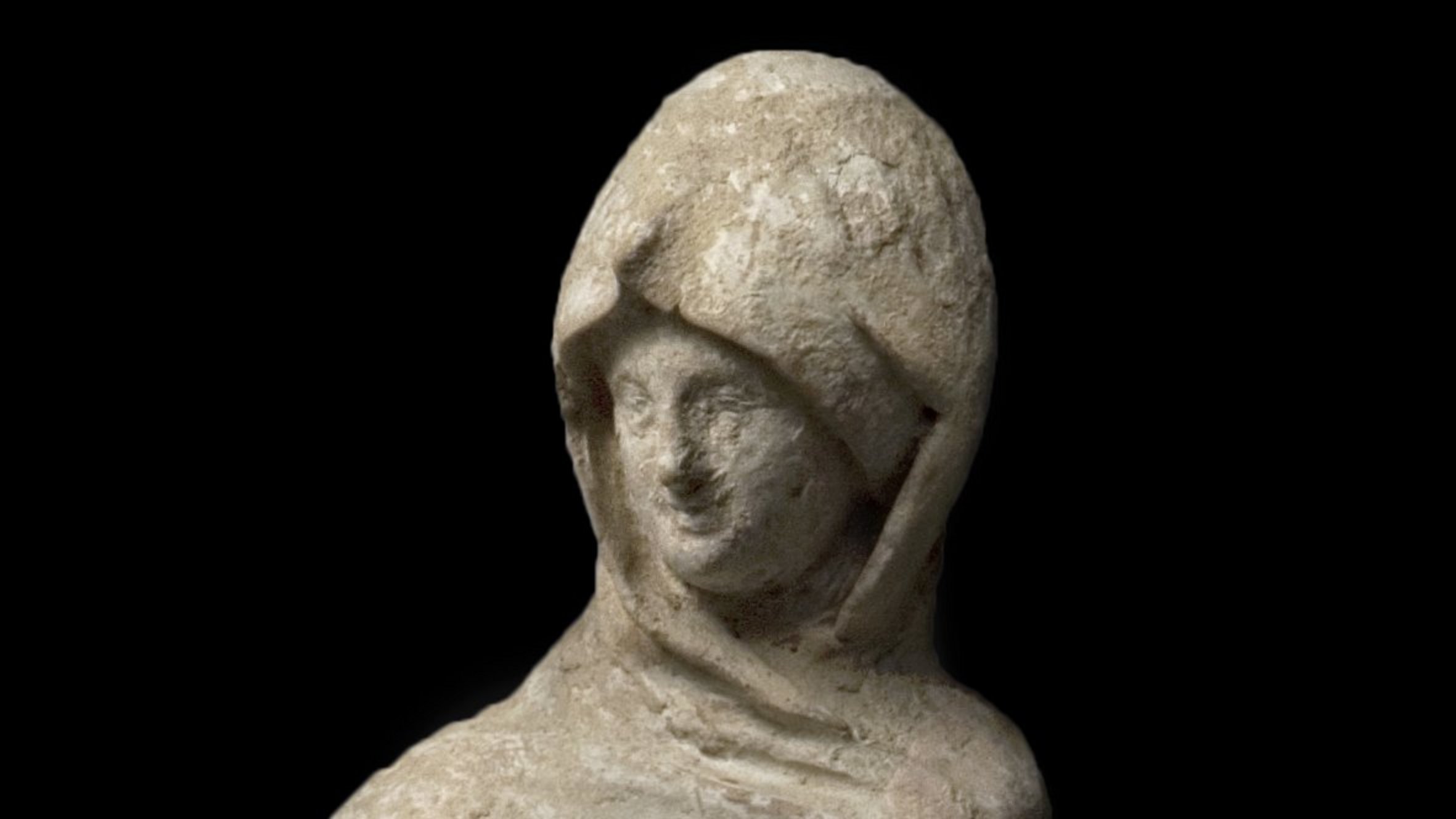 Female robed figure, the cloak pulled over her head and one hand put into the cloak; the other holds a fan or mirror