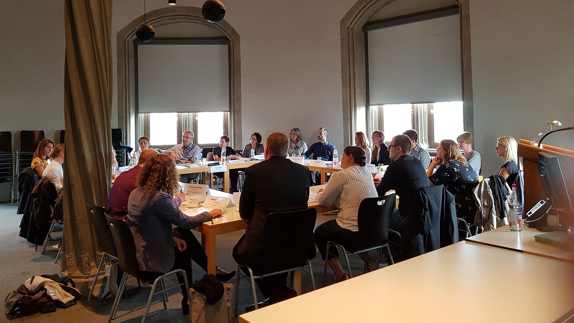Participants of the workshop sitting at the working tables