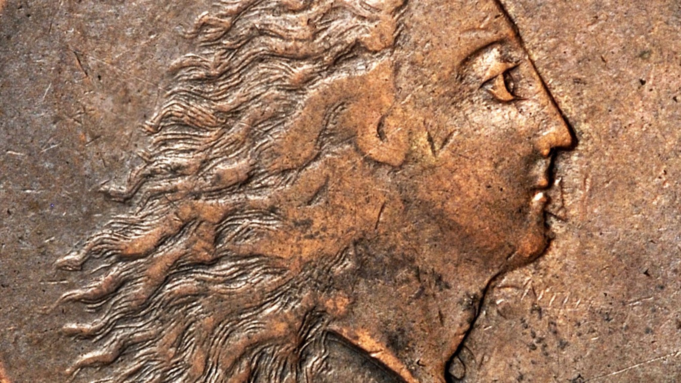 Obverse of a copper coin with a female portrait looking to the right; her hair drifts openly behind her; above is the inscription "LIBERTY", beneath "1793"