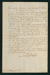 Fotografie eines alten handschriftlichen Dokuments auf leicht vergilbtem Papier. Der Text ist in deutscher Kurrentschrift oder einer ähnlichen historischen Schreibweise verfasst und erstreckt sich über die gesamte Seite. Am unteren Rand befindet sich eine Unterschrift. Das Dokument ist von einem dunklen Rahmen umgeben.