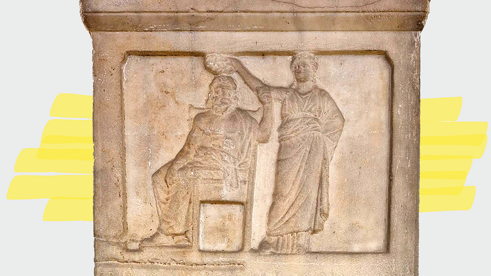 Close-up of a stele with a bas-relief depicting a female figure (Demokratia, right) holding a wreath over the head of a seated male figure (personification of the citizenry, left).