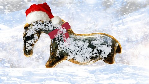 Foto: MUT Nach links gewandtes Urzeitpferdchen aus Mammutelfenbein mit einer Weihnachtsmütze in einer Schneelandschaft