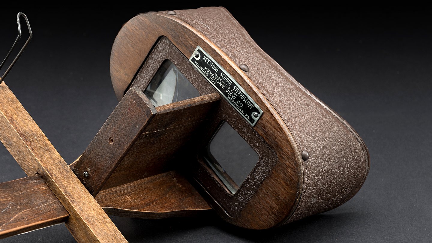 Stereoscope made by Keystone View Company, 1947. The stereoscope, made of wood and glass lenses, allows two-dimensional images to be perceived as three-dimensional objects