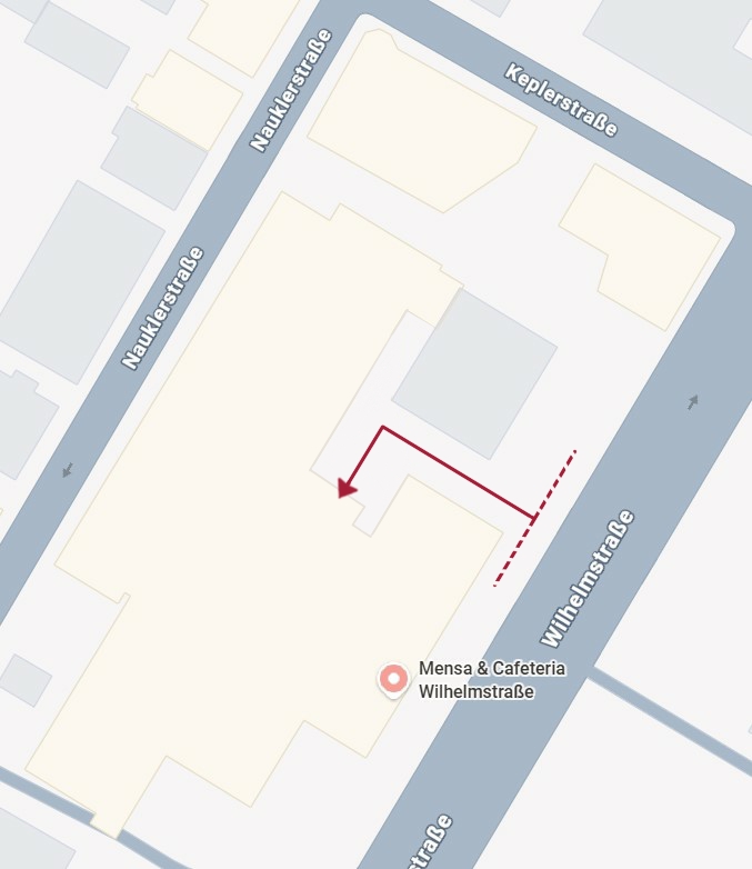 This is a schematic map of the Wilhelmstraße canteen and the surrounding streets. A dark red arrow shows the footpath from Wilhelmstraße, which is on the side of the building, to the rear of the building.